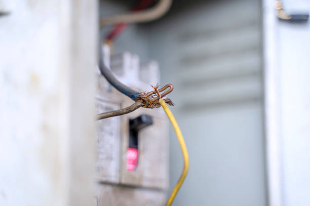 Broken electric line in factory. Shield is opening. Show copper wire inside. Risk concept.