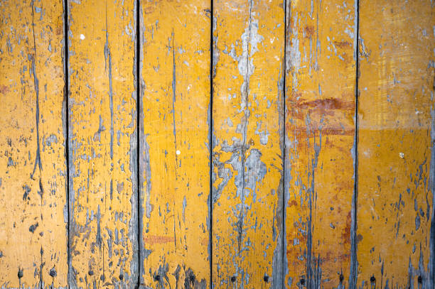 istock Old boards with cracked yellow paint. Classic rustic background. 1372068733