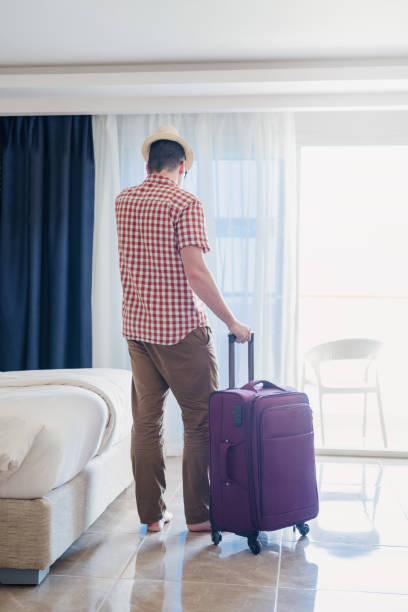 istock Handsome Caucasian young man packing his suitcase for travel 1372071970