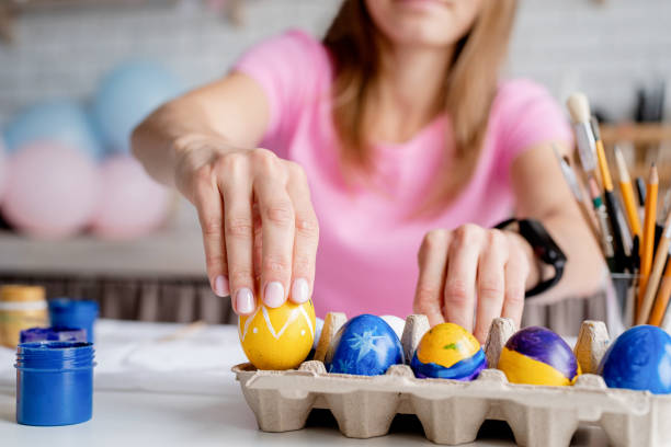 istock Woman coloring Easter eggs in the kitchen 1372072188