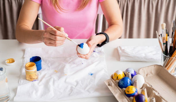 istock Woman coloring Easter eggs in the kitchen 1372072272