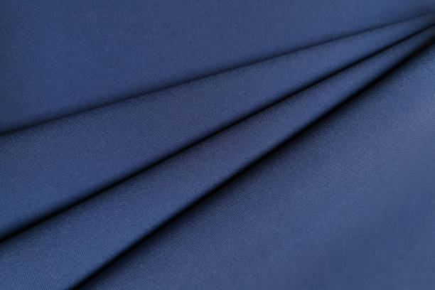 istock Blue crumpled or wavy fabric texture background. Abstract linen cloth soft waves. Gabardine wool fabric. Merino yarn. Smooth elegant luxury cloth texture. Concept for banner or advertisement 1372072317