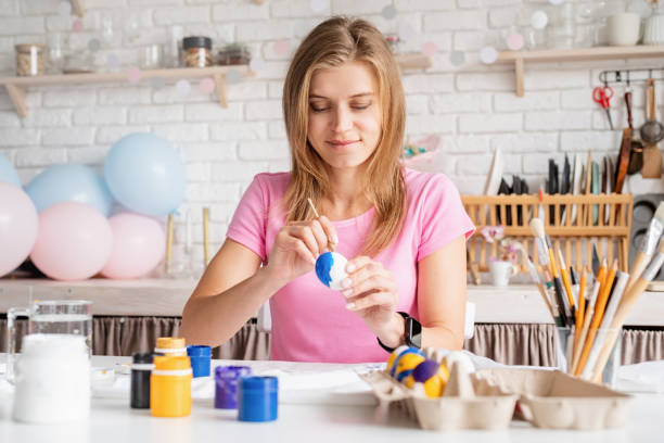 istock Woman coloring Easter eggs in the kitchen 1372073281