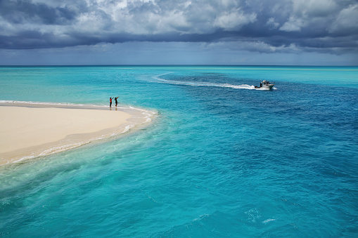 Boat going through the channel between Mouli and Ouvea Islands, Loyalty Islands archipelago, New Caledonia.