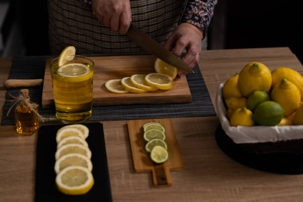 istock women's hands cutting lemons and limes 1372075106