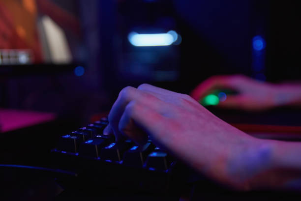 istock Gamer play computer game, use rgb neon colored keyboard 1372077189