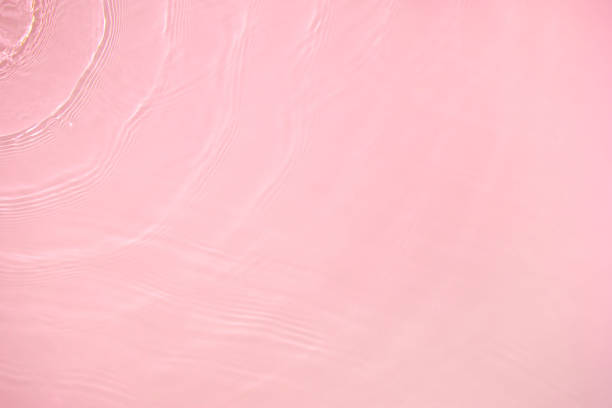 istock transparent pink colored clear calm water surface texture 1372077273