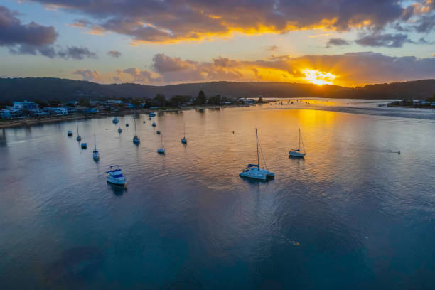 istock Aerial sunrise waterscape with boats 1372079339