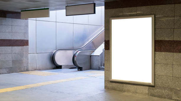 Train station Train station interior with escalator and empty poster on concrete wall underground station stock pictures, royalty-free photos & images