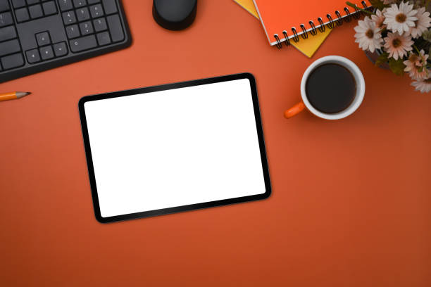 istock Flat lay, mockup digital tablet, coffee cup and notebook on orange background. 1372081153