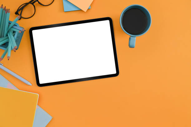 istock Flat lay digital tablet, coffee cup, glasses and stationery on yellow background. 1372081312