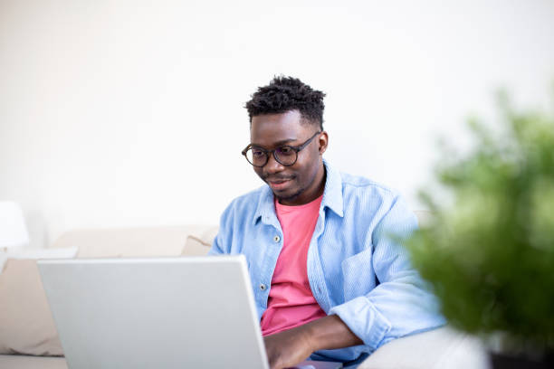 istock Young and determined black student studying at night at home, with a help of a laptop computer, and having a internet call. 1372081323