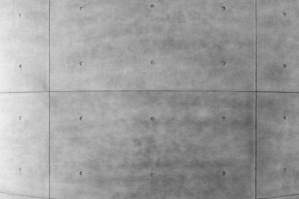 Exposed gray concrete wall, cement texture, gray background, building with cement exterior