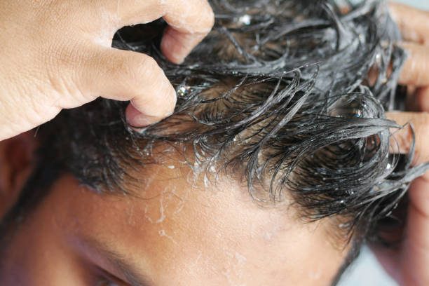 istock young men washes his hair with shampoo . 1372083080