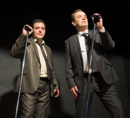 Two male performers on stage.