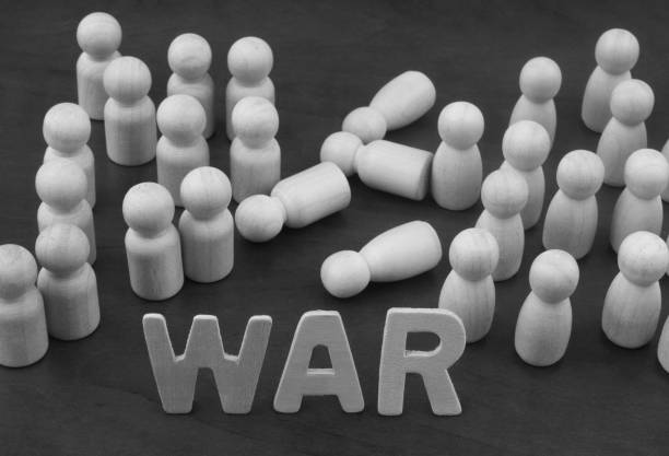 Two groups of different wooden people figures and word WAR. War concept. Two groups of different wooden people figures and word WAR. special forces vietnam stock pictures, royalty-free photos & images