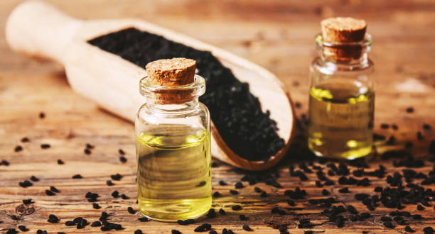 istock Black cumin essential oil in a small bottle. Selective focus. 1372089294