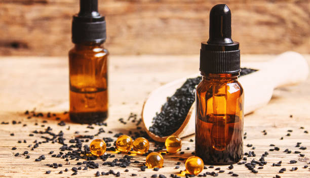 istock Black cumin essential oil in a small bottle. Selective focus. 1372089300