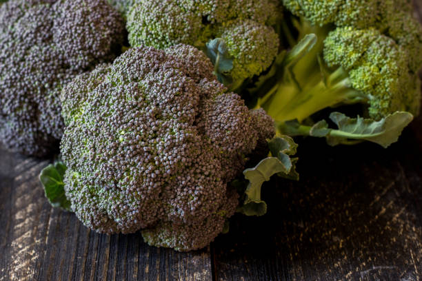 istock Freshly harvested organic Barese broccoli, on black wooden background 1372090258