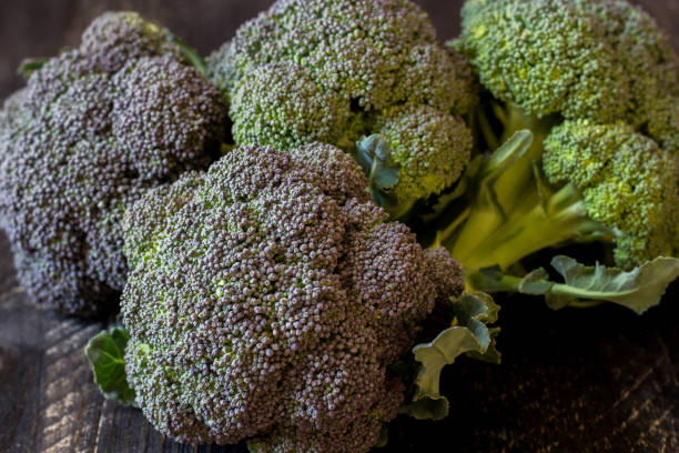 istock Freshly harvested organic Barese broccoli, on black wooden background 1372091081