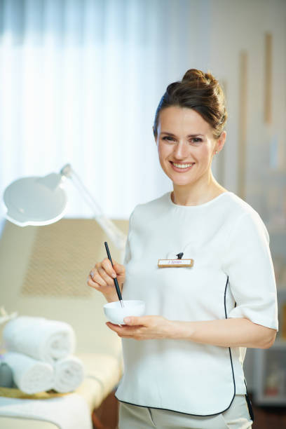 happy female worker in modern beauty studio working stock photo