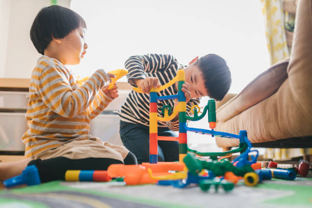 istock Siblings playing together at home 1372092920