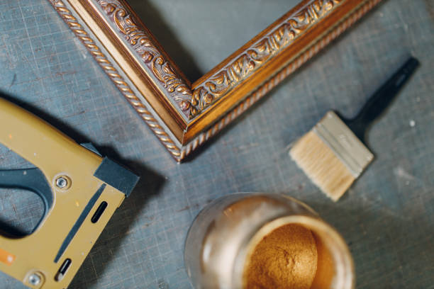 Framing Workshop. Making baguette handmade picture frame at studio Framing Workshop. Painting baguette handmade picture frame at studio. hand cropping photos stock pictures, royalty-free photos & images