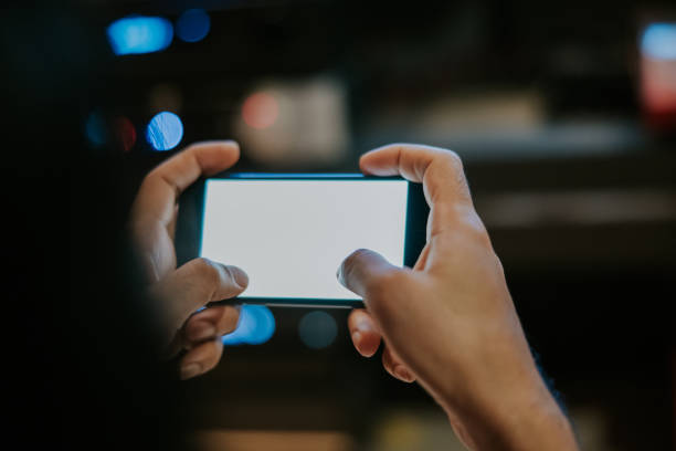 istock Using phone for playing game nightlife at home 1372094022