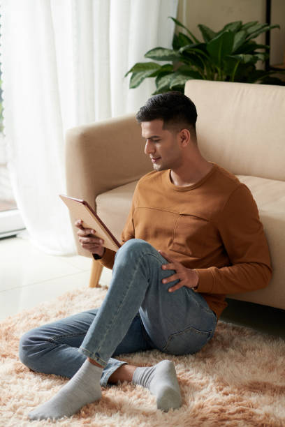 istock Man watching the movie on tablet pc 1372094153