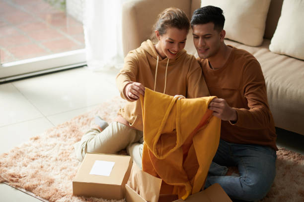 Couple getting the parcel with clothes stock photo