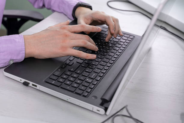 istock Man working at home office hand on keyboard close-up 1372094491