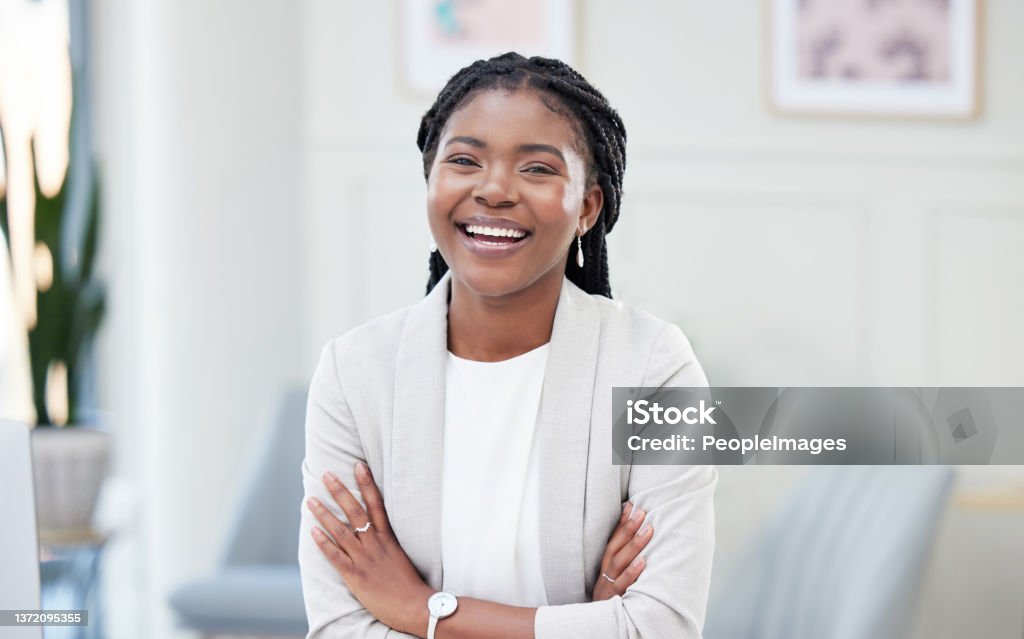 Shot of a young businesswoman taking a break in her office her joy shines from within Businesswoman Stock Photo