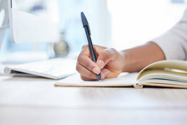 istock Shot of a businesswoman making notes in her notebook 1372095421