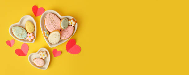 istock Sweets, pastry, gingerbread cookies for Easter table. Easter eggs heart shaped decor  on yellow background top view copy space, spring seasonal holiday banner for your site, flyer, coupon 1372095532