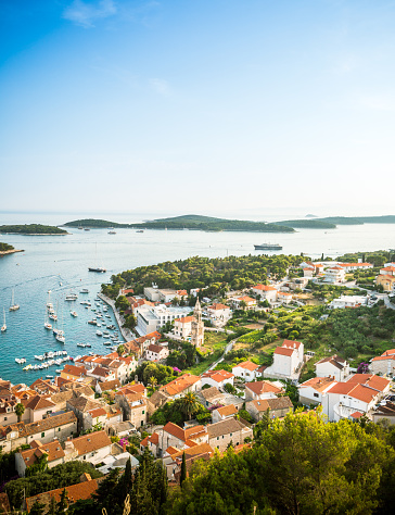 Wonderful romantic summer afternoon landscape panorama coastline Adriatic sea. A narrow mountain road above the cliffs along the coast.
The clear azure water in the bay. Hvar island. Croatia. Europe.