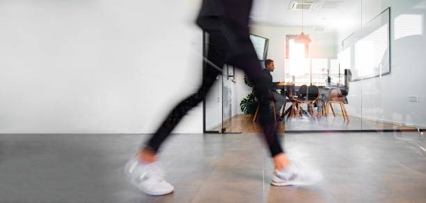 istock Business people walking through the office corridor 1372099441