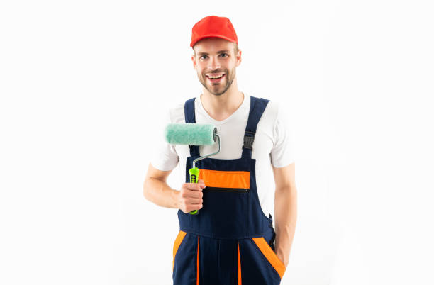 istock happy man in builder uniform hold paint roller isolated on white background, painter 1372099591