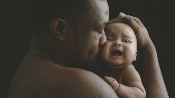 istock Black father holding a baby 1372099751