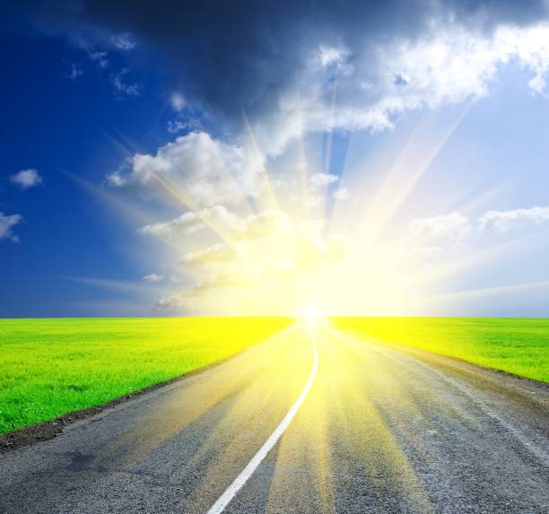 istock asphalt road leaving far to a sunrise 1372100471