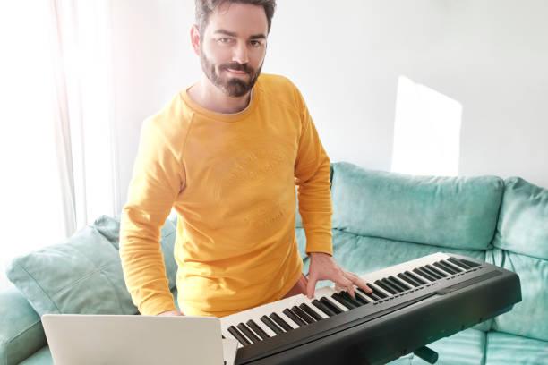 istock young man have fun playing digital piano at home 1372101226