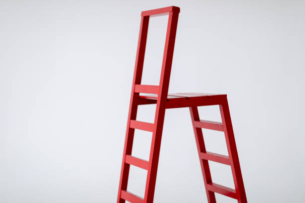 istock Red wooden staircase on a light background. Ladder. Garden tools. Lifting device. 1372101765