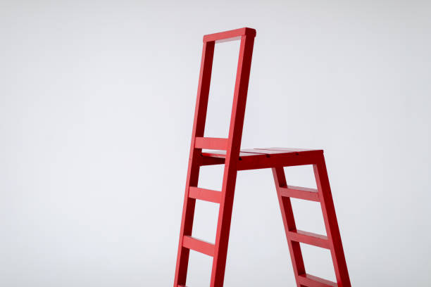 istock Red wooden staircase on a light background. Garden tools. Lifting device. 1372101768