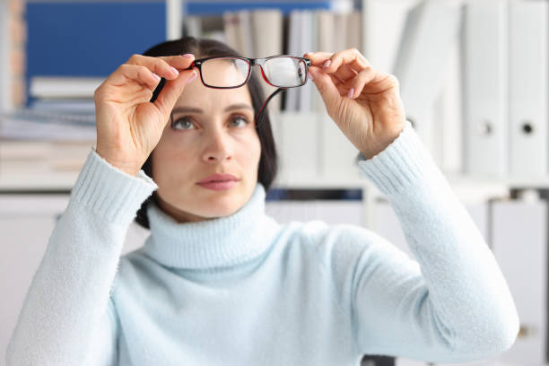 istock Tired worker with irritated eyes looks at glasses 1372101771