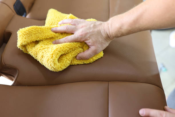 istock Man cleaning leather car seat with microfiber cloth 1372101796