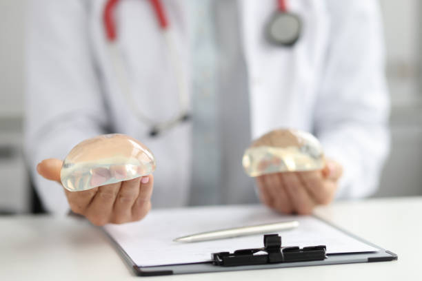 istock Doctor plastic surgeon holds silicone chest implants 1372101840
