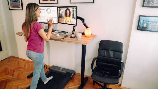 istock Standing desk home office with under desk treadmill 1372102075