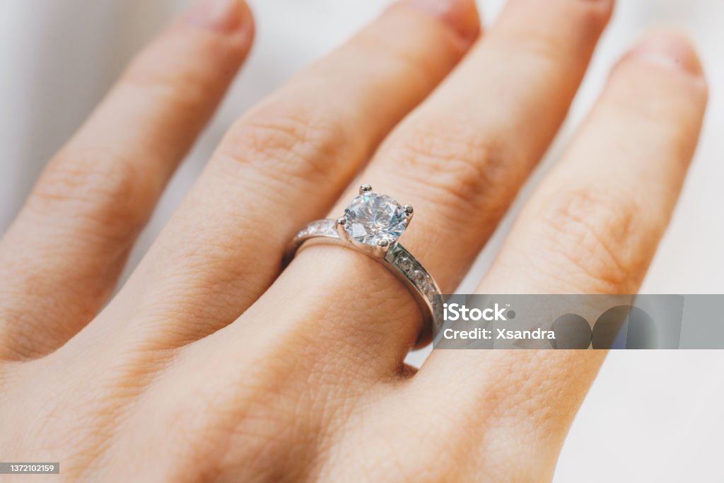 Close up of a woman hand with a diamond ring Ring - Jewelry Stock Photo