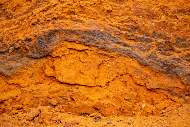 istock Textural sand, with  relief surface, multi-colored layers and different in size of granules, in outdoor sand career, after mining ore and sand for construction. 1372102197