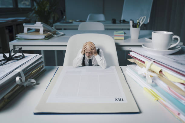istock Shocked businessman checking a tax form 1372104467