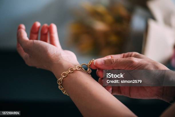 An Asian Womens Hand Showing Luxury Accessories Such As Gold Bracelet Stock Photo - Download Image Now